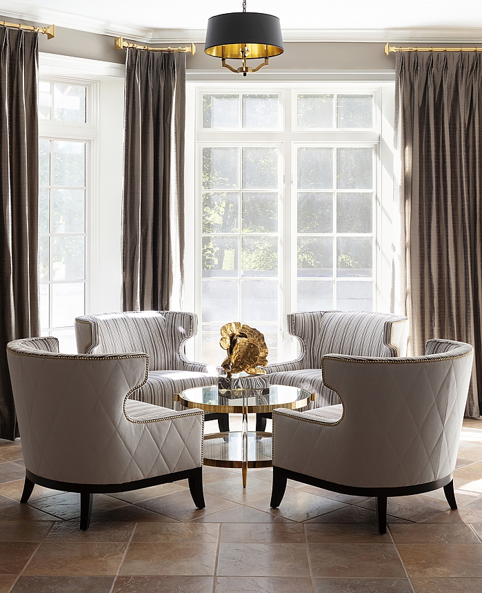 Luxury living with custom upholstered chairs and drapery.
